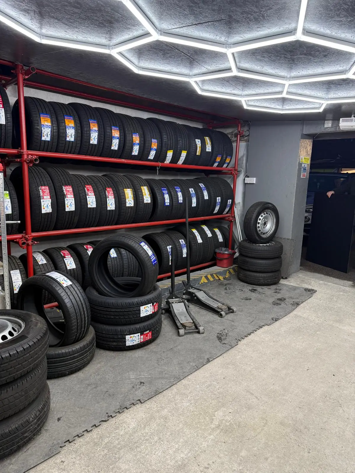 Tyre stacks on red shelving racks at Platinum Tyres Doncaster